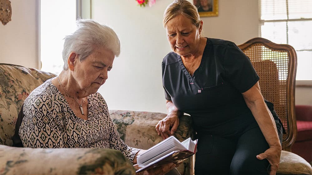 caregiver-and-senior-woman-reading-v01